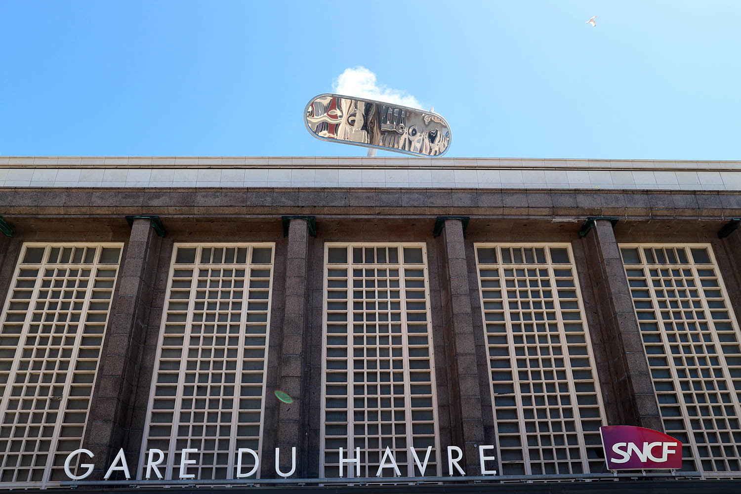 Parcours Les Bassins. Über dem Hauptportal des 1932 von Henri Victor Pacon errichteten Hauptbahnhofs schimmert ein riesiger Spiegel, die Installation "L'Altoviseur" von Julien Berthier.